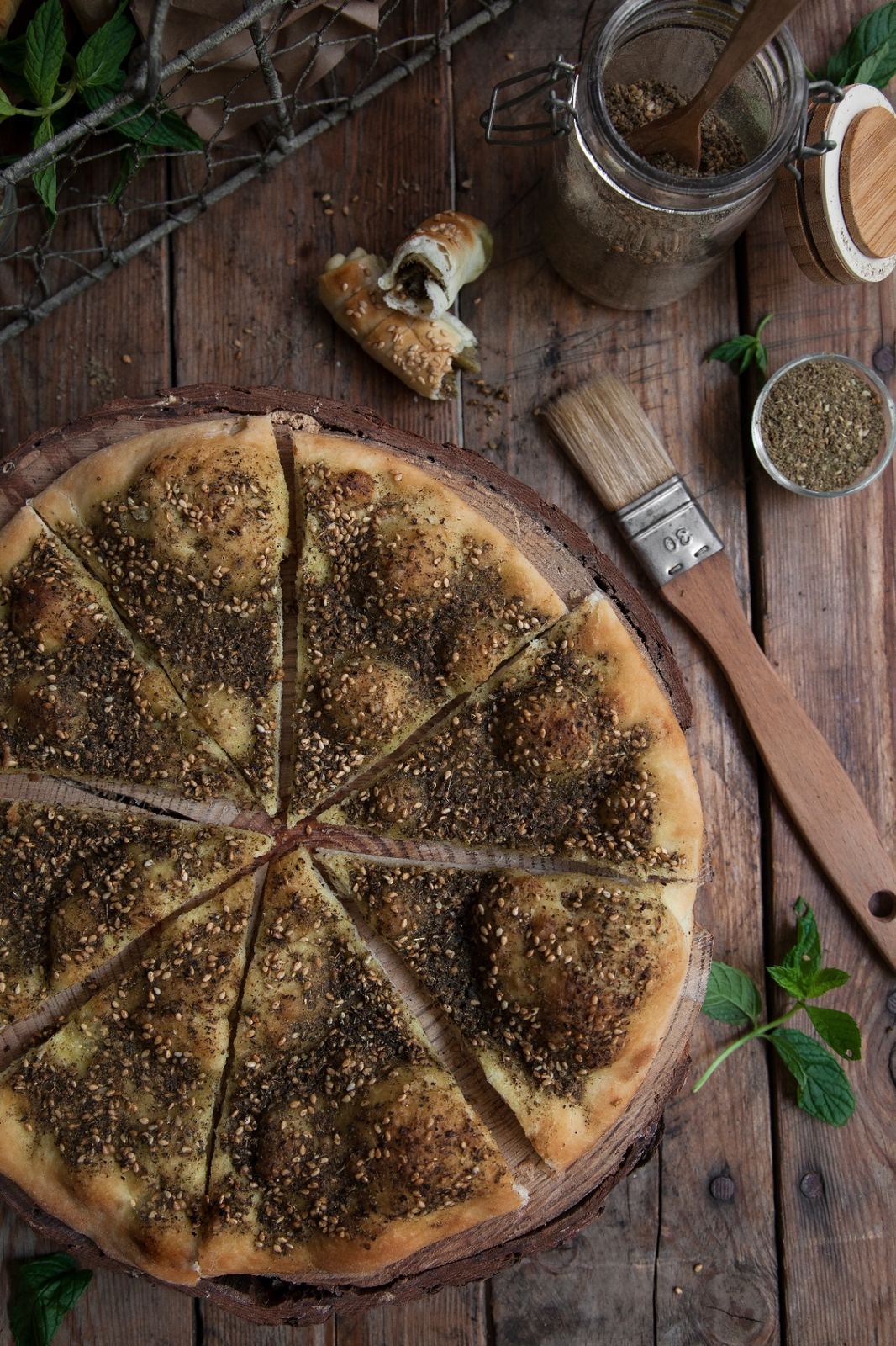 Fresh zaatar manoushe sliced on a wooden board